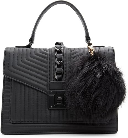 Black quilted handbag with fur pom-pom on a white background